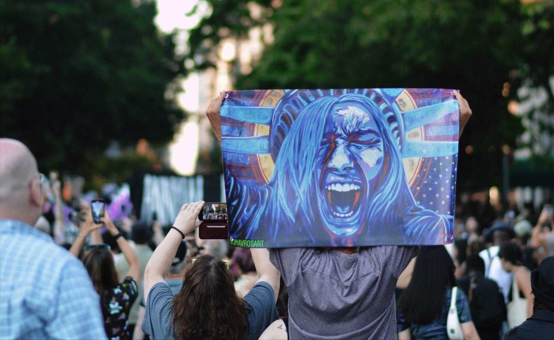 

Lady Liberty protest sign with distressed American flag artwork
Protect democracy political vynil banner displayed outdoors
Anti fascism activist flag featuring Lady Liberty
Patriotic protest sign for outdoor display
Original political artwork flag supporting democracy

JMAVROSART 